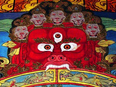 A Tibetan wall painting in Sumtseling monastery depicting Yama, the Lord of Death who holds the wheel of life in his clutches